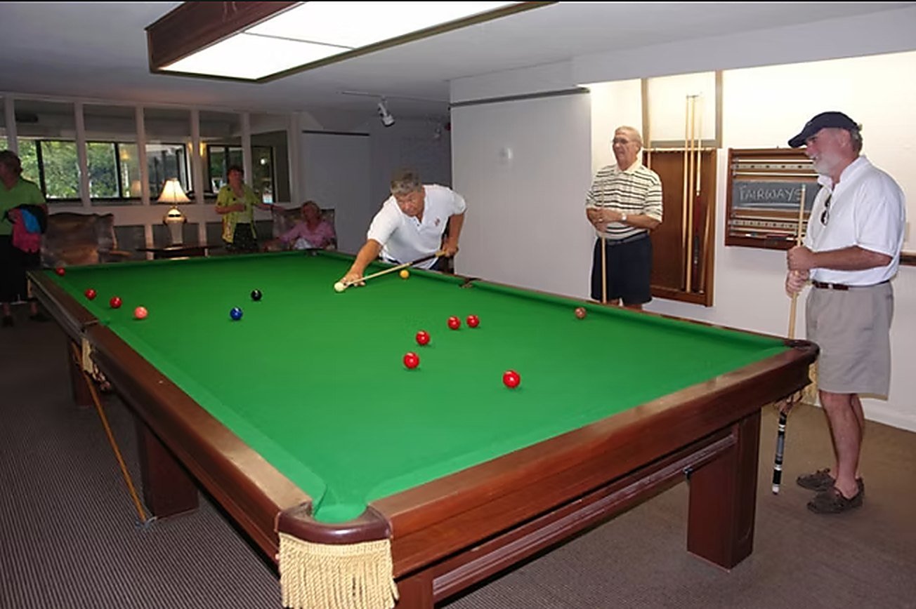 Residents playing billiards in the games room